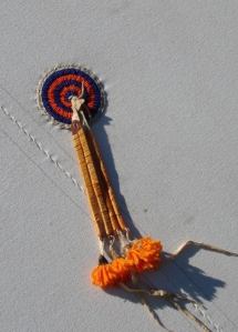 Attached to a friend's tipi, the rosette is a representation of the Cheyenne Women's Sewing Society group.  "If you can make the rosettes'. beaded back panel, pillows, tipis, and other accoutrements, you then are a member of the society," Linda says.